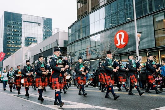 A lively parade featuring a magnificent bagpipe band through city streets