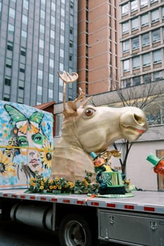 Colorful parade float with a whimsical animal head and vibrant artwork