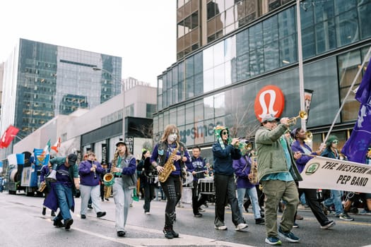 A colorful parade with talented musicians and vibrant banners through city streets
