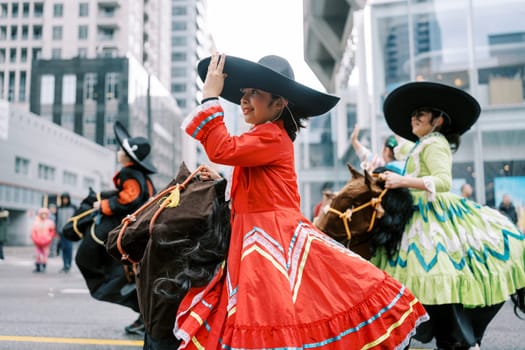 Dancers showcase their cultural traditions during a lively, joyous parade event