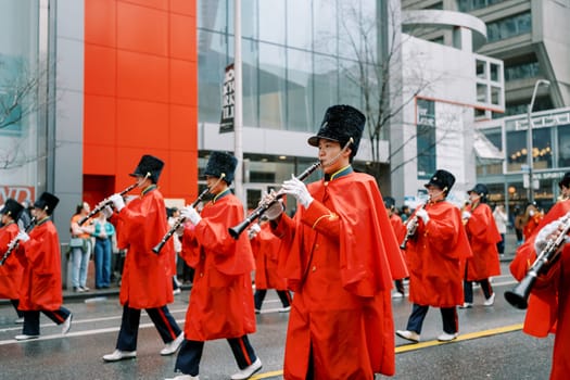 A vibrant parade with talented musicians in red capes and tall hats, enhancing festivity
