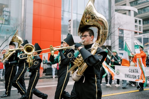 A dynamic marching band showcases their musical talent at a street parade