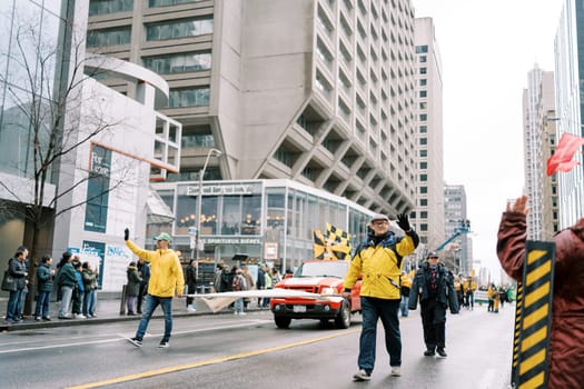 A colorful parade with lively participants in bright attire celebrating together