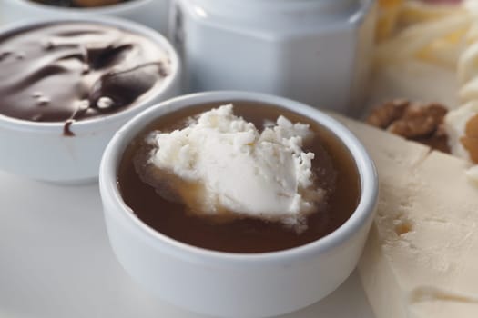 A variety of sweet toppings is paired with a creamy dip for dessert.