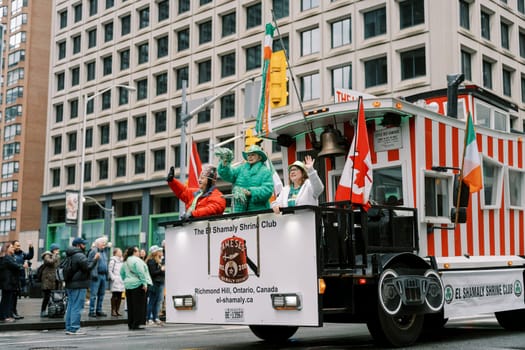 Participants on a vibrant float celebrating culture in a lively parade