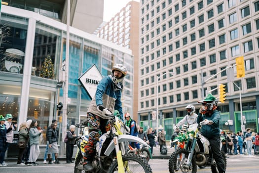 An exciting and dynamic scene featuring motorcyclists riding through a busy city street