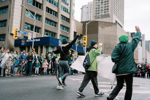 Exciting parade featuring enthusiastic participants in vibrant green outfits.