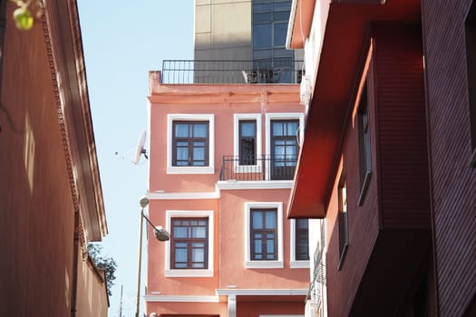 Vibrant architecture stands tall along a narrow street in the city.