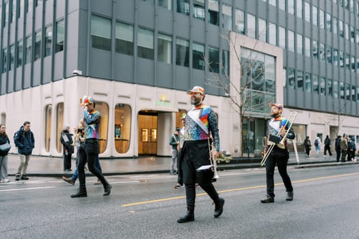 A lively marching band performs energetically in a bustling city street, captivating all