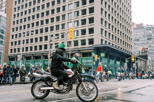 A motorcyclist navigating through a vibrant urban environment showcasing city life
