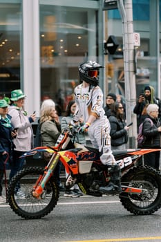 A motocross rider displays amazing skills at an event, thrilling the audience
