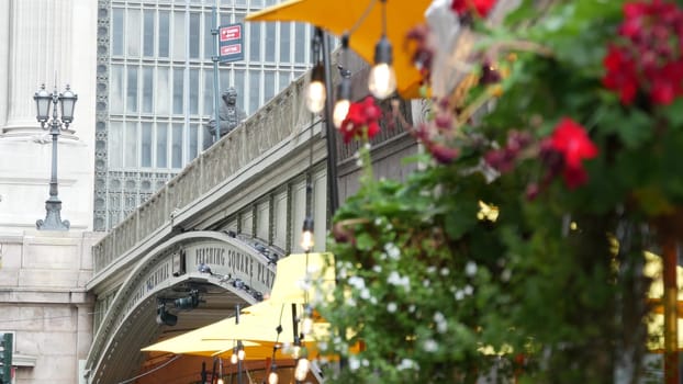New York City, United States - 4 Sept 2023: Grand Central Terminal railway station, 42 street. American Manhattan Midtown. Bridge on Pershing Square, NYC, USA. Light bulb garland, umbrella and flowers