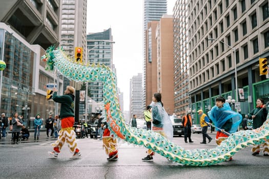 Colorful dragon dance performance in urban setting celebrates tradition