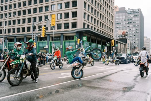 Thrilling motorcycle stunt riders performing incredible skills in urban city streets