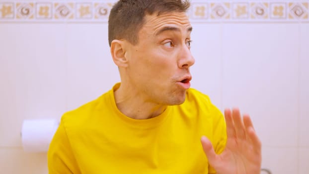 A man has been in the bathroom for too long and someone tells him to finish already