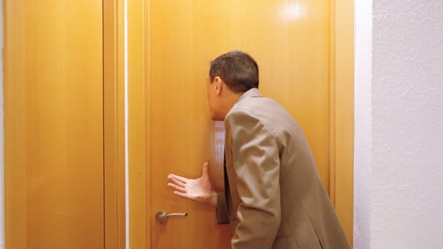 Angry man waiting for his wife who is taking too long to get ready