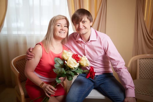 A middle-aged couple enjoys a special moment together, captured at a cozy hotel during their Valentine's celebration.