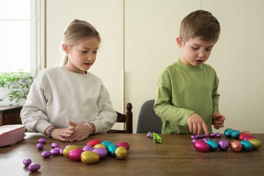 Children at home collect chocolate eggs