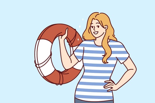Lifeguard woman with lifebuoy smiles guaranteeing safety of pool visitors or people relaxing on seashore. Girl in sailors vest demonstrates lifebuoy to rescue those who have fallen overboard