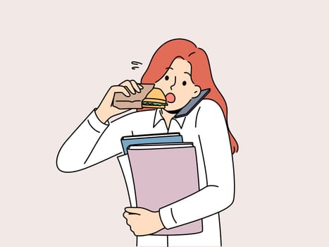 Busy multitasking woman answers phone biting on sandwich to save time at lunch. Young businesswoman with folders in hands eats and works in multitasking mode, wishing to succeed in career