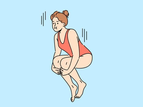 Woman swimmer jumps from springboard to dive underwater into pool or sea. Girl in swimsuit dives into pool while participating in ski jumping or synchronized swimming competitions.