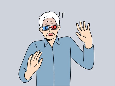 Elderly man in cinema glasses gets scared sees 3d special effects in movie for first time. Grey-haired pensioner in glasses exclaims and waves hands watching modern film with 3d effect