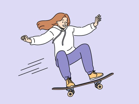 Brave girl skateboarder makes aerial stunt by bouncing on ramp in skatepark. Smiling young woman riding skateboard and enjoying extreme sports wanting to become professional skateboarder