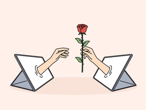 Hand with rose in tablet is metaphor for online relationships and dating using digital gadgets. Online flirting and sending virtual gifts through social network app for distance relationships concept