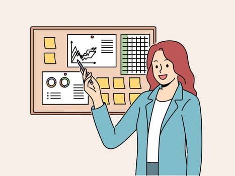 Businesswoman demonstrates financial graphs and charts pinned on cork board in office. Businesswoman boasts about growth of company income and number of clients that bring income to business.