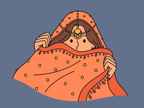 Indian woman hides face behind national dress during traditional cultural ritual or ethnic wedding. Hindu girl model in Indian saree clothes with precious jewelry hiding wanting to intrigue partner