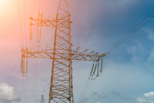 High voltage towers with sky background. Power line support with wires for electricity transmission. High voltage grid tower with wire cable at distribution station. Energy industry, energy saving.