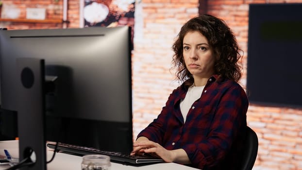 AI startup company developer testing company software to minimize occurrence of bugs, identifying bottlenecks. Woman in office writing code in programming language to reduce errors