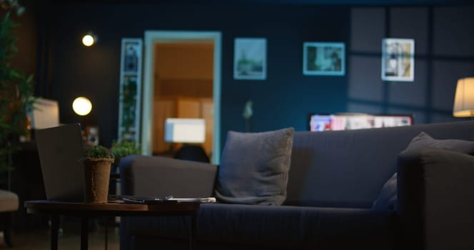 Cozy apartment with modern decor and trendy electronics creating a relaxation space, stylish minimalist studio loft with a smart tv and a coffee table. Comfortable home with indoor plants.