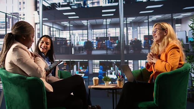 Ambitious businesswomen collaborating in a corporate office, fostering gender equality in a men dominated business industry. and leadership growth. Success driven powerful leaders. Camera B.