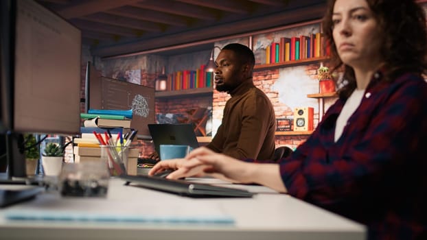 AI startup IT expert arriving in office with laptop, preparing to look for company security vulnerabilities. Software development agency admin coming at work with notebook to do coding, camera A