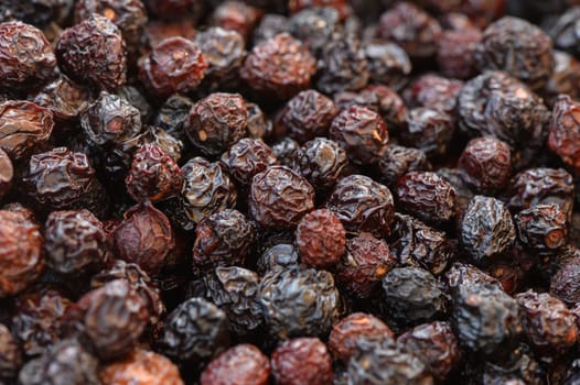 Deeply colored dried berries create an inviting visual tapestry, showcasing their varied textures and seasonal charm.