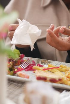 woman cleaning her hand with napkin.