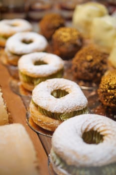 An assortment of pastries showcases sweet treats at a bakery counter.