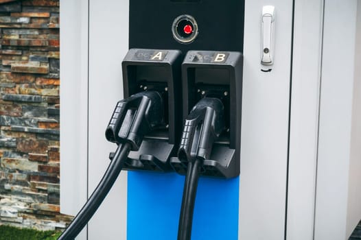 charging cable at an modern energy electric charging station for charge electric automobiles close-up