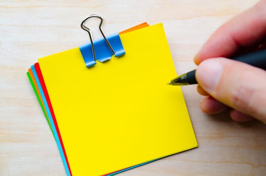 Top view of yellow notepad with customizable space for text.