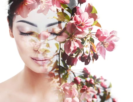 Unity of human with nature, beauty of youth and femininity. Double exposure portrait of young pretty woman combined with bright spring garden flowers
