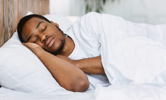 Asleep African American Guy Sleeping Resting Peacefully In His Comfortable Bed At Home, Lying With Eyes Closed. Recreation, Deep Male Sleep, Time To Rest And Nap Concept.
