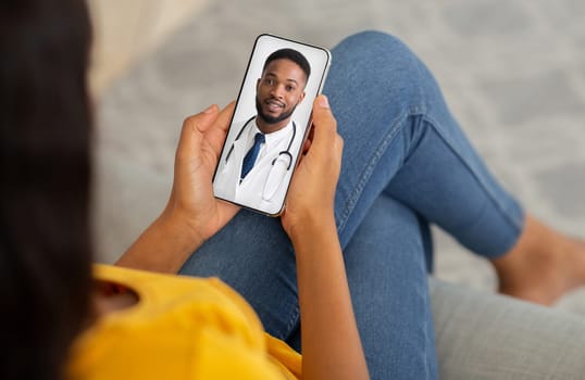 Telemedicine Concept. Unrecognizable Black Lady Using Smartphone, Making Video Conference With Her Therapist Doctor While Sitting On Couch At Home. Male Physician Consulting Patient Online, Collage