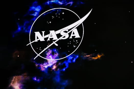 NASA logo with space background. Space travel concept. Copenhagen, Denmark - March 15, 2025