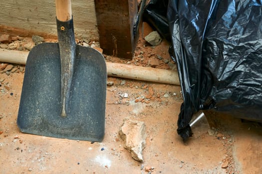 a tool with a broad flat blade and typically upturned sides