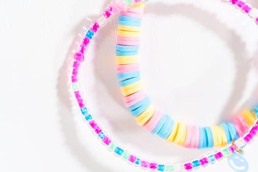 Little girl's charming bracelets adorned with clay and sea beads.