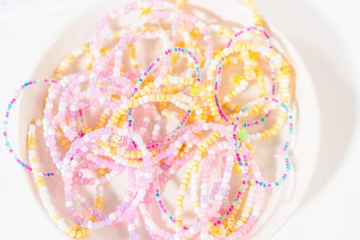 Little girl's charming bracelets adorned with clay and sea beads.