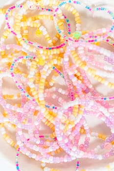 Little girl's charming bracelets adorned with clay and sea beads.