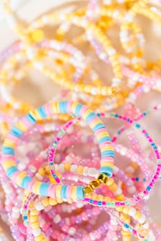 Little girl's charming bracelets adorned with clay and sea beads.