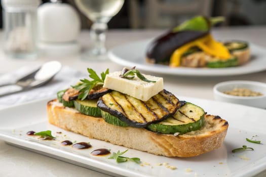 A vibrant grilled vegetable appetizer features zucchini and eggplant layered on crusty bread, topped with cheese and fresh herbs. The cozy dining atmosphere enhances the culinary experience.